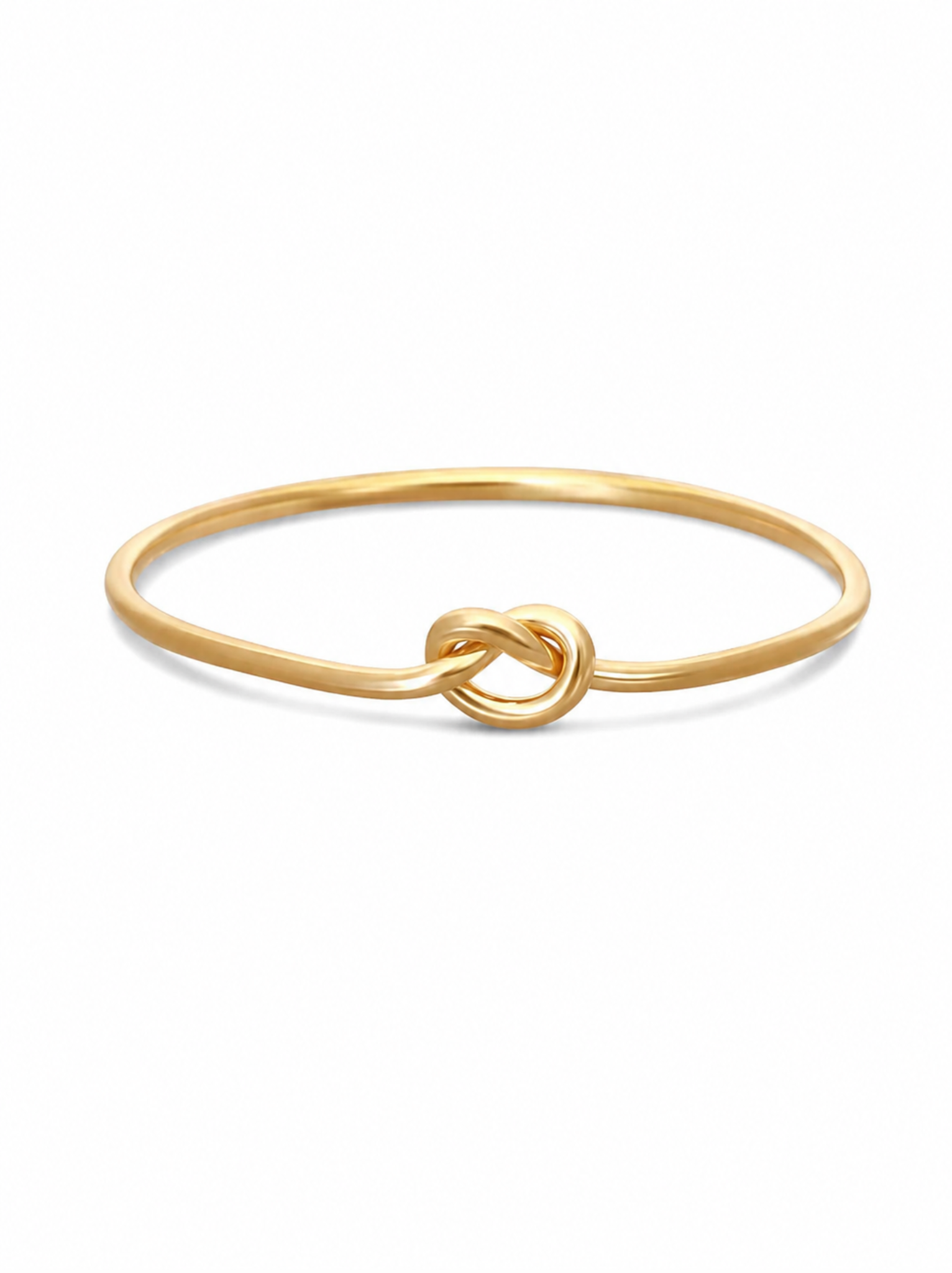 Gold ring with knotted detail on white background.