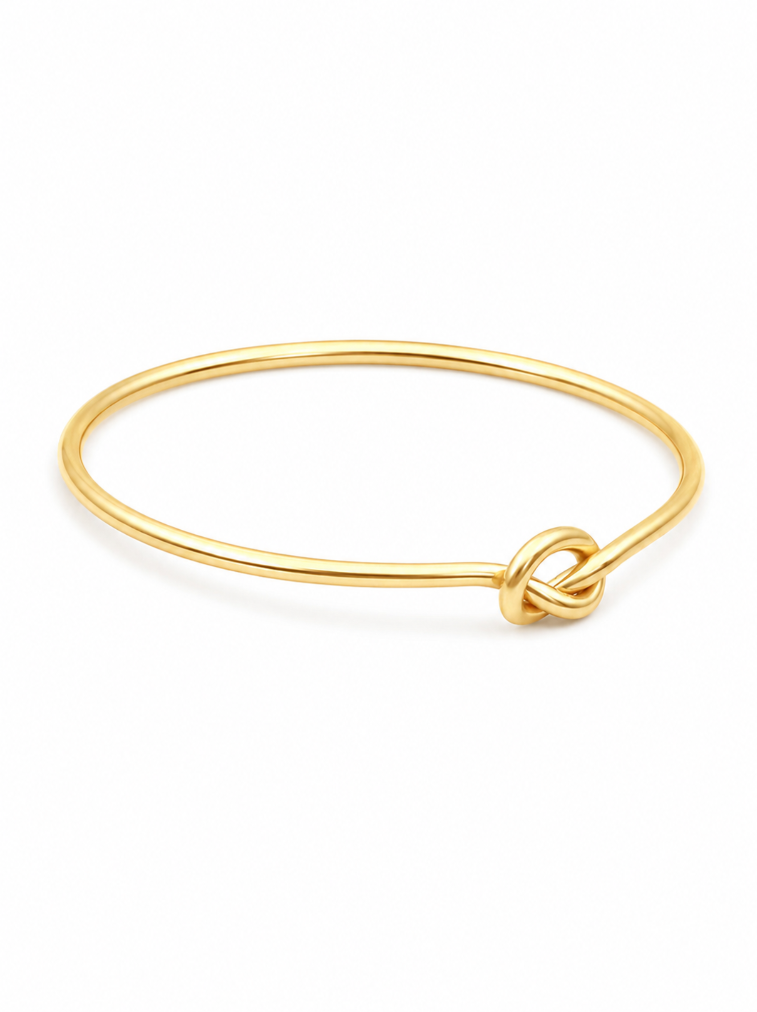 Angled view of a gold ring with knotted detail on white background.