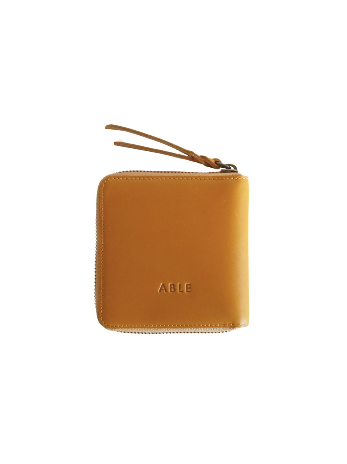 The back of a square cognac leather wallet with brand logo on a white background. #Color_Cognac
