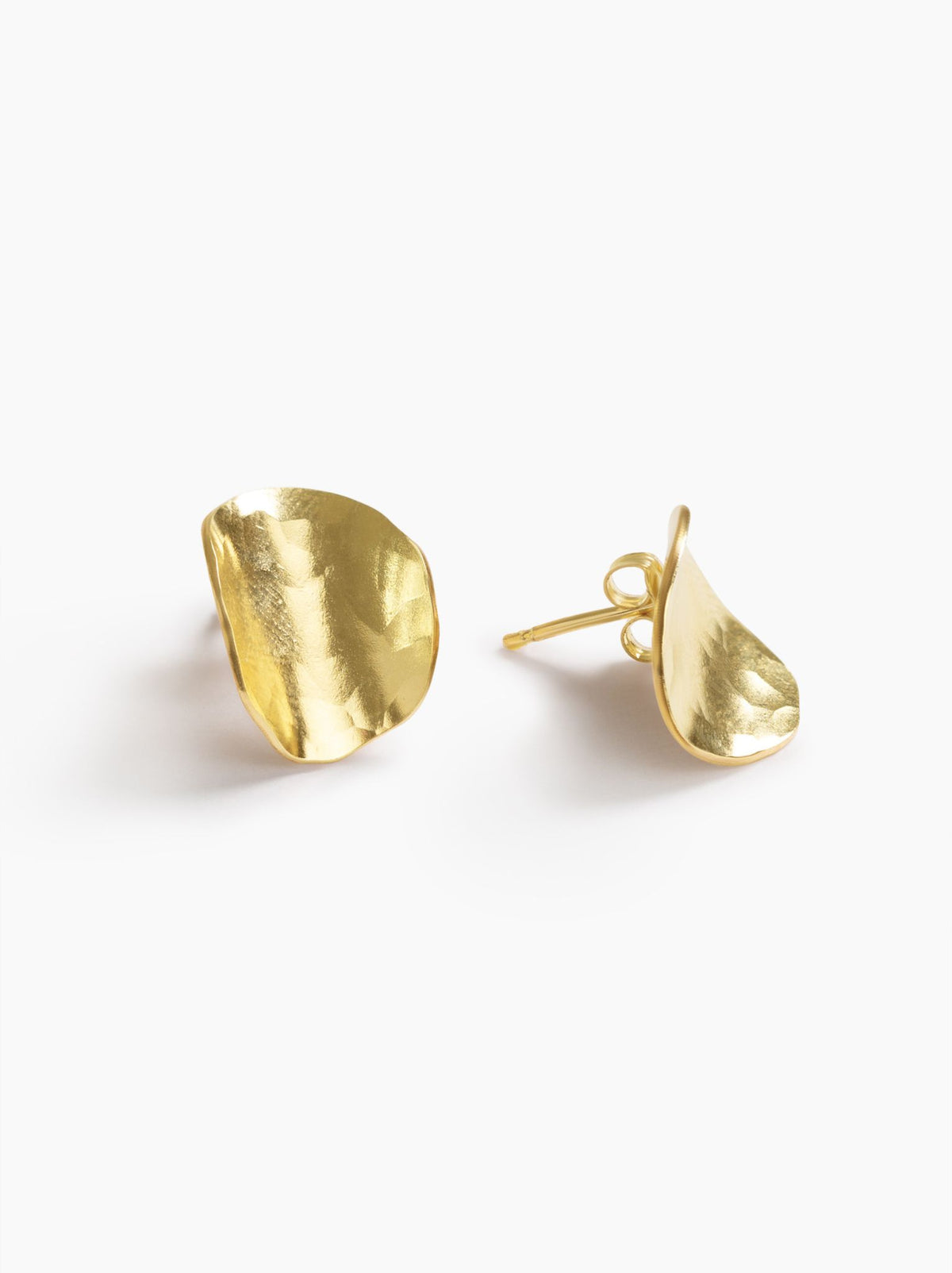 Side and post view of a pair of gold disc-like stud earrings on a white background.