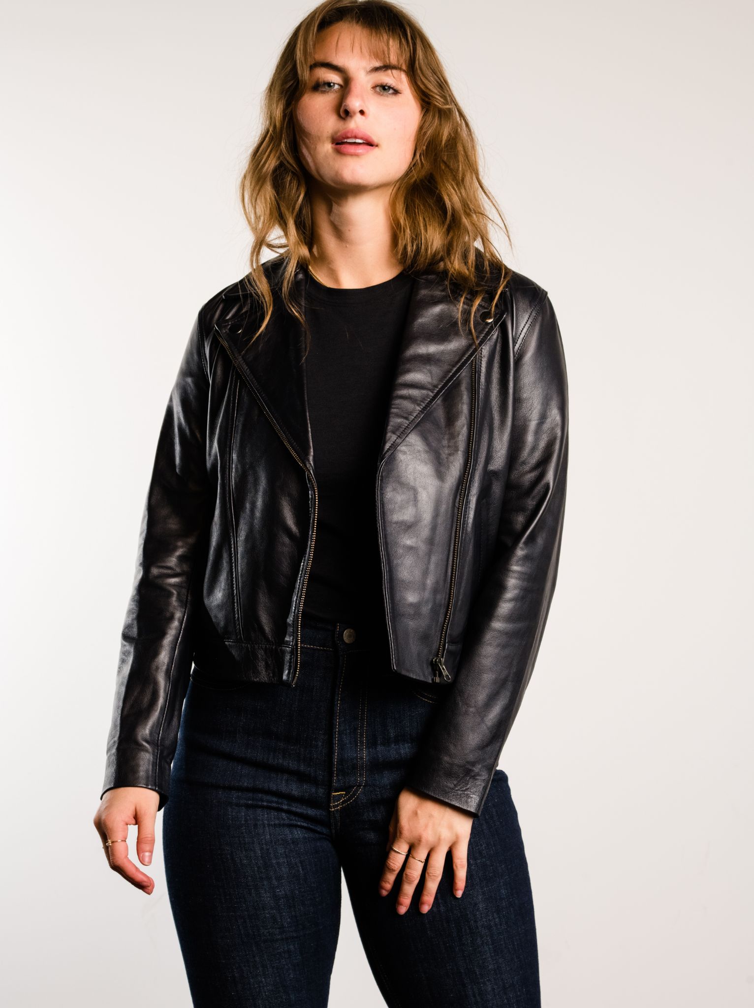 A woman wearing a black Maha Leather Jacket.