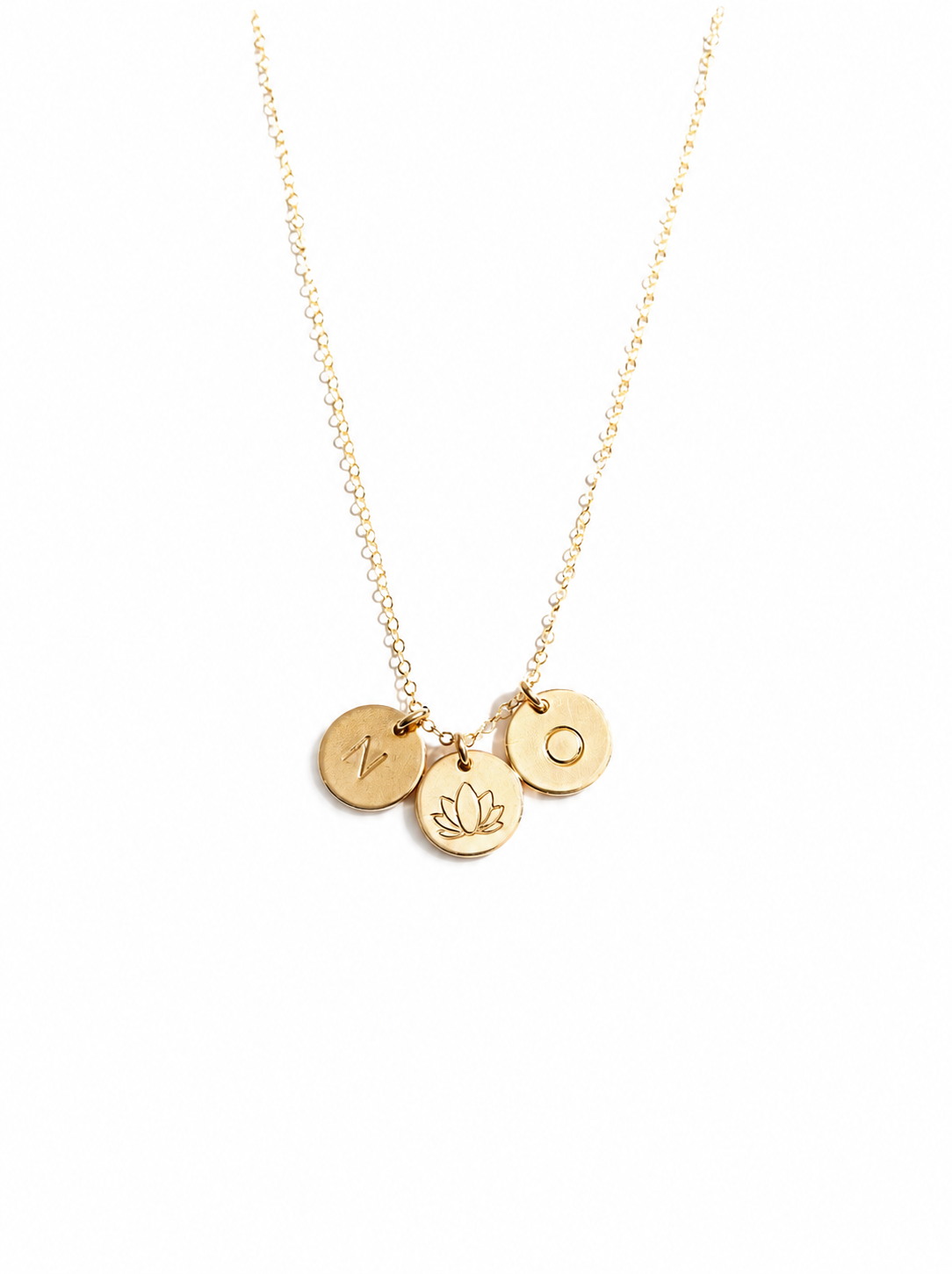 A delicate gold chain necklace featuring three small round gold charms, each stamped with a different letter or symbol (N, lotus, O) displayed on a clean white background.