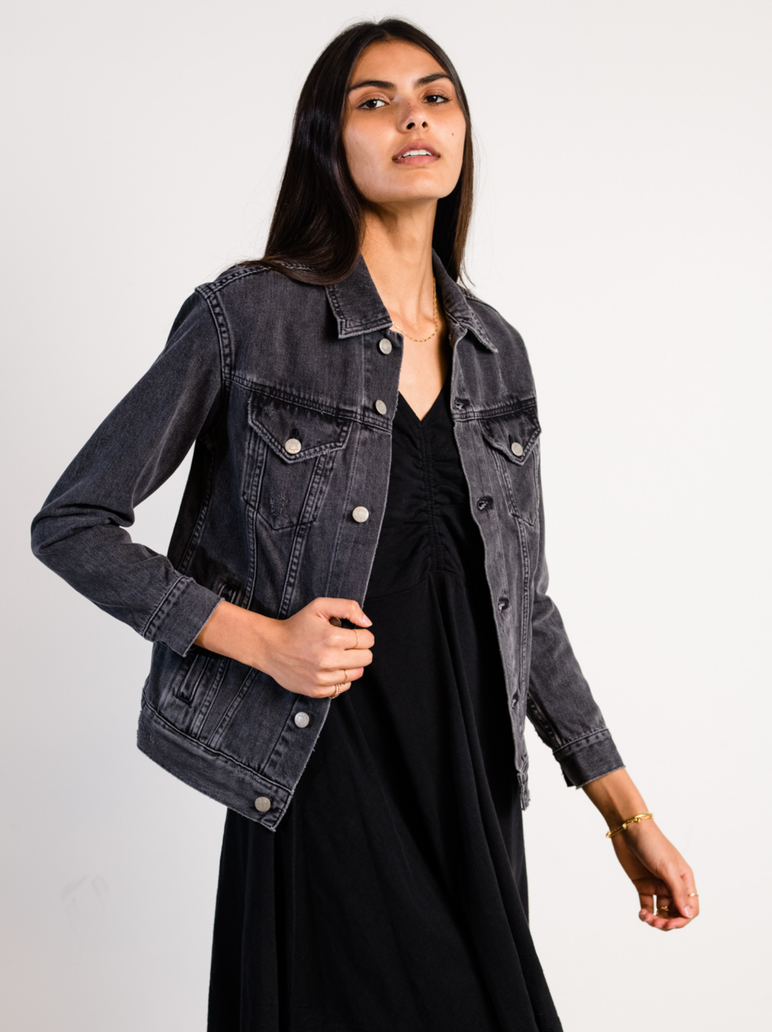 Woman wearing The Merly Jacket Washed Black over a black dress on a white background