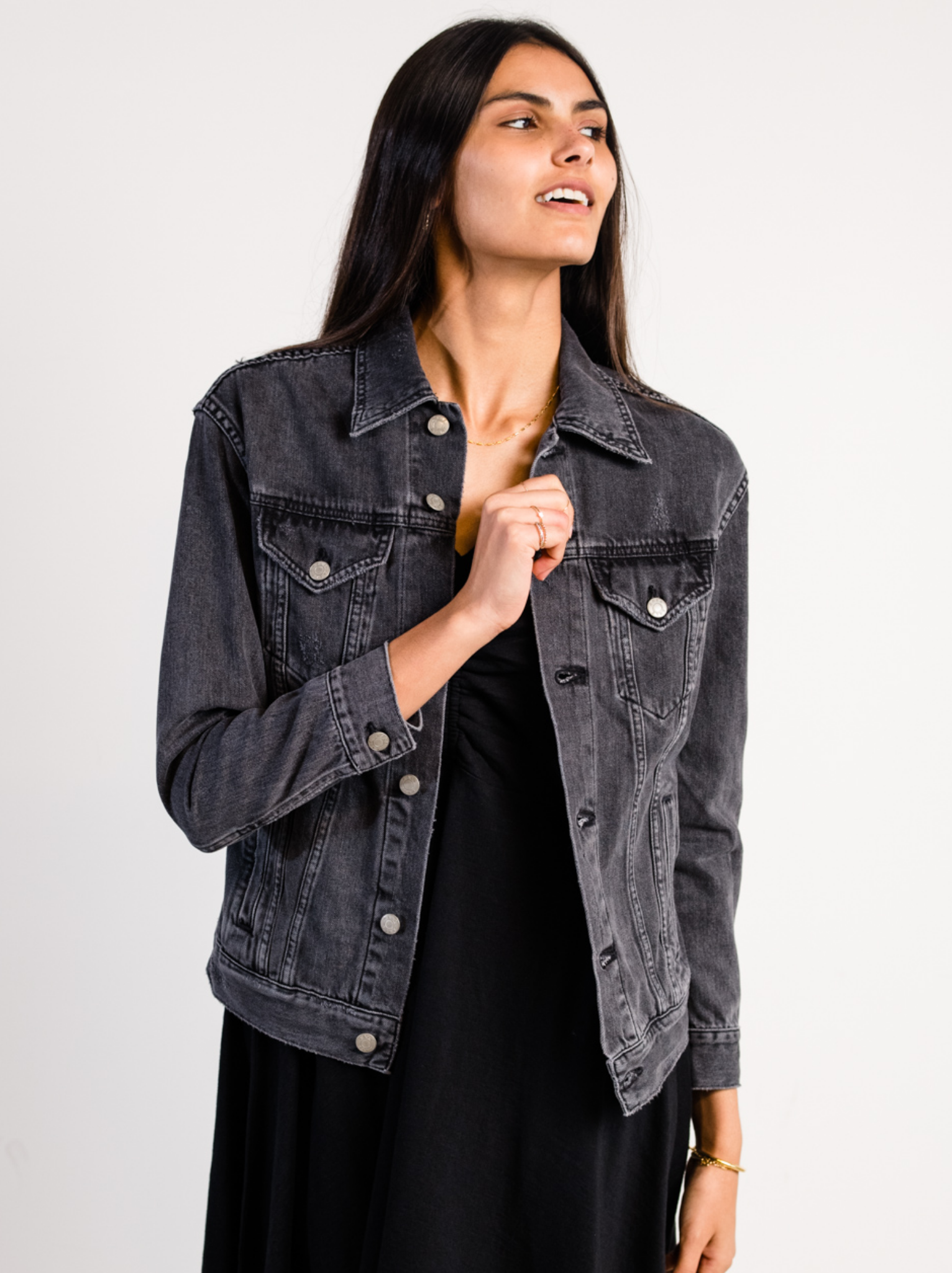 Woman wearing The Merly Jacket Washed Black against a plain background