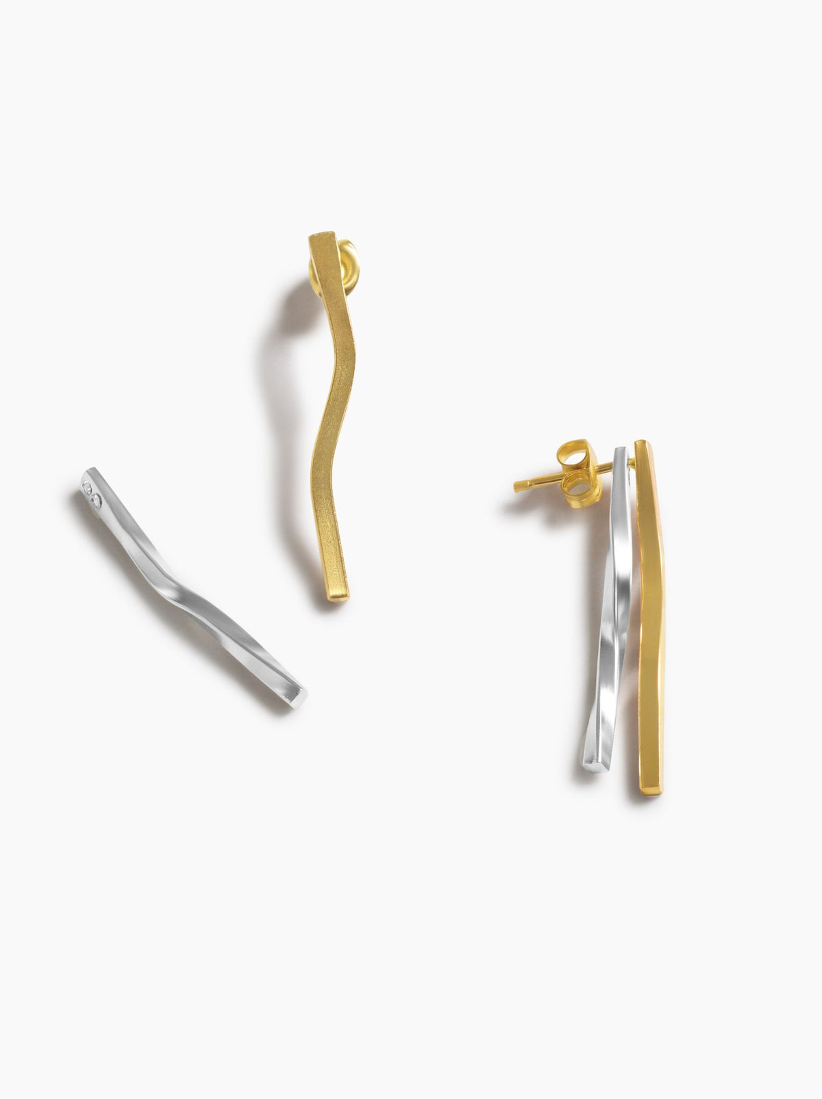 Two-tone gold and silver earrings, showing each color can be worn individually, on a white background.