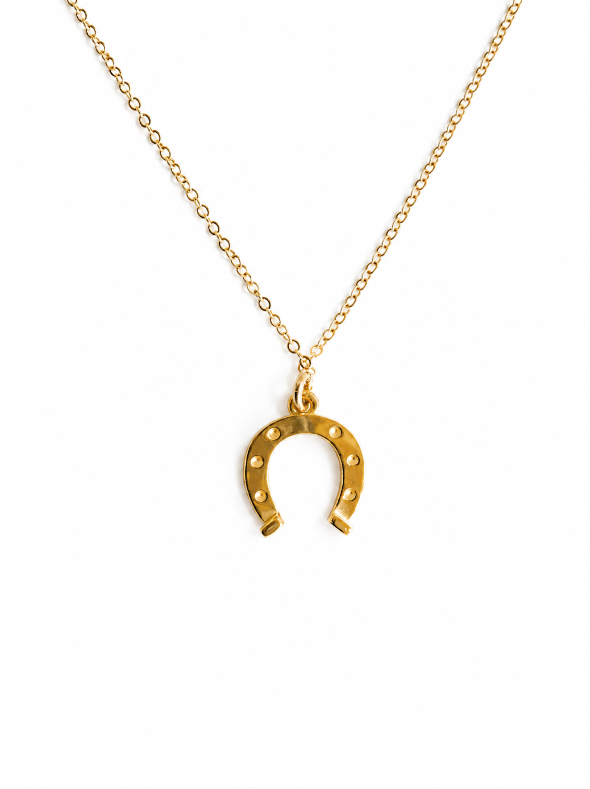 Gold horseshoe necklace on a white background