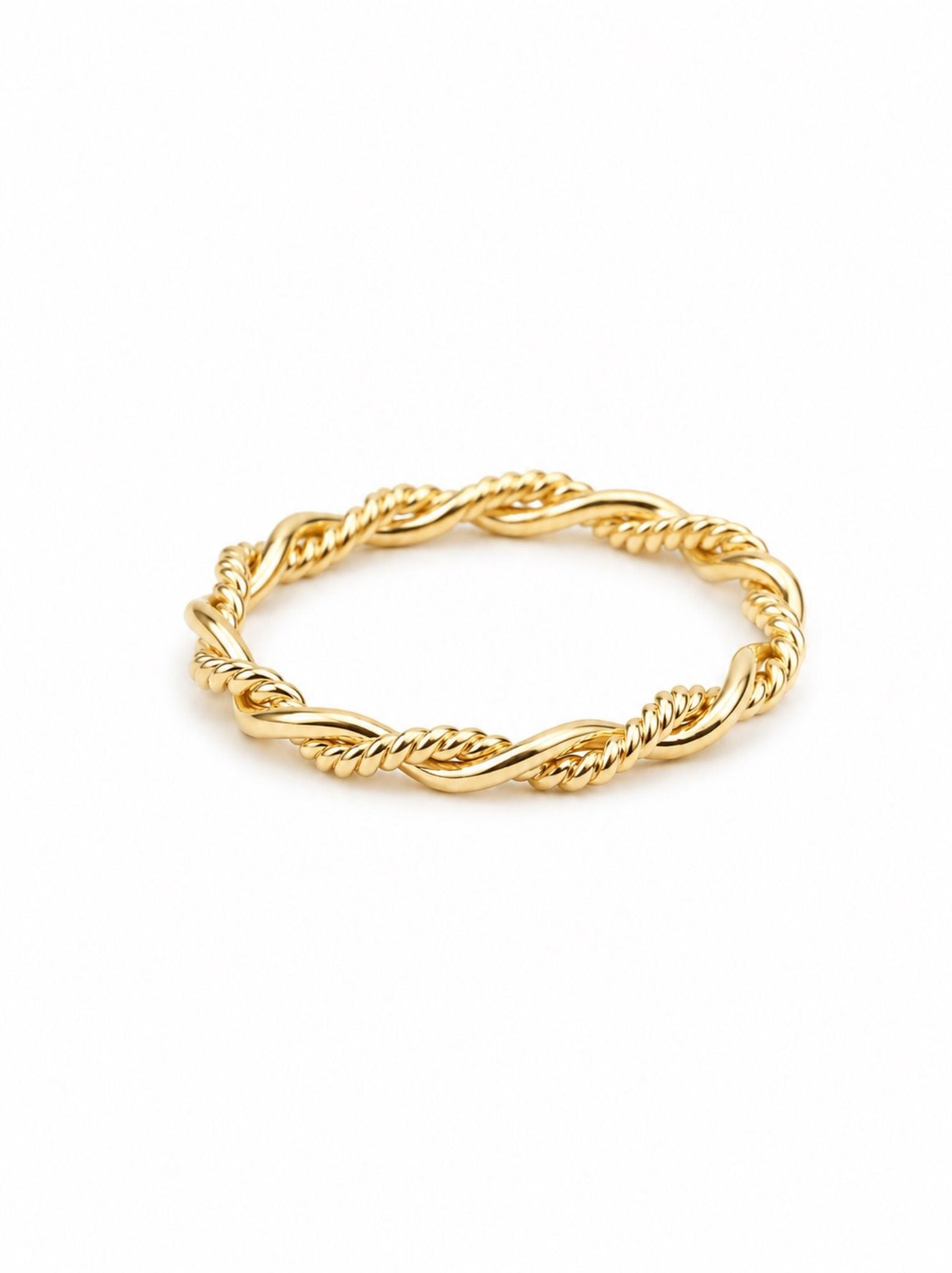 Gold ring with braided design on a white background.
