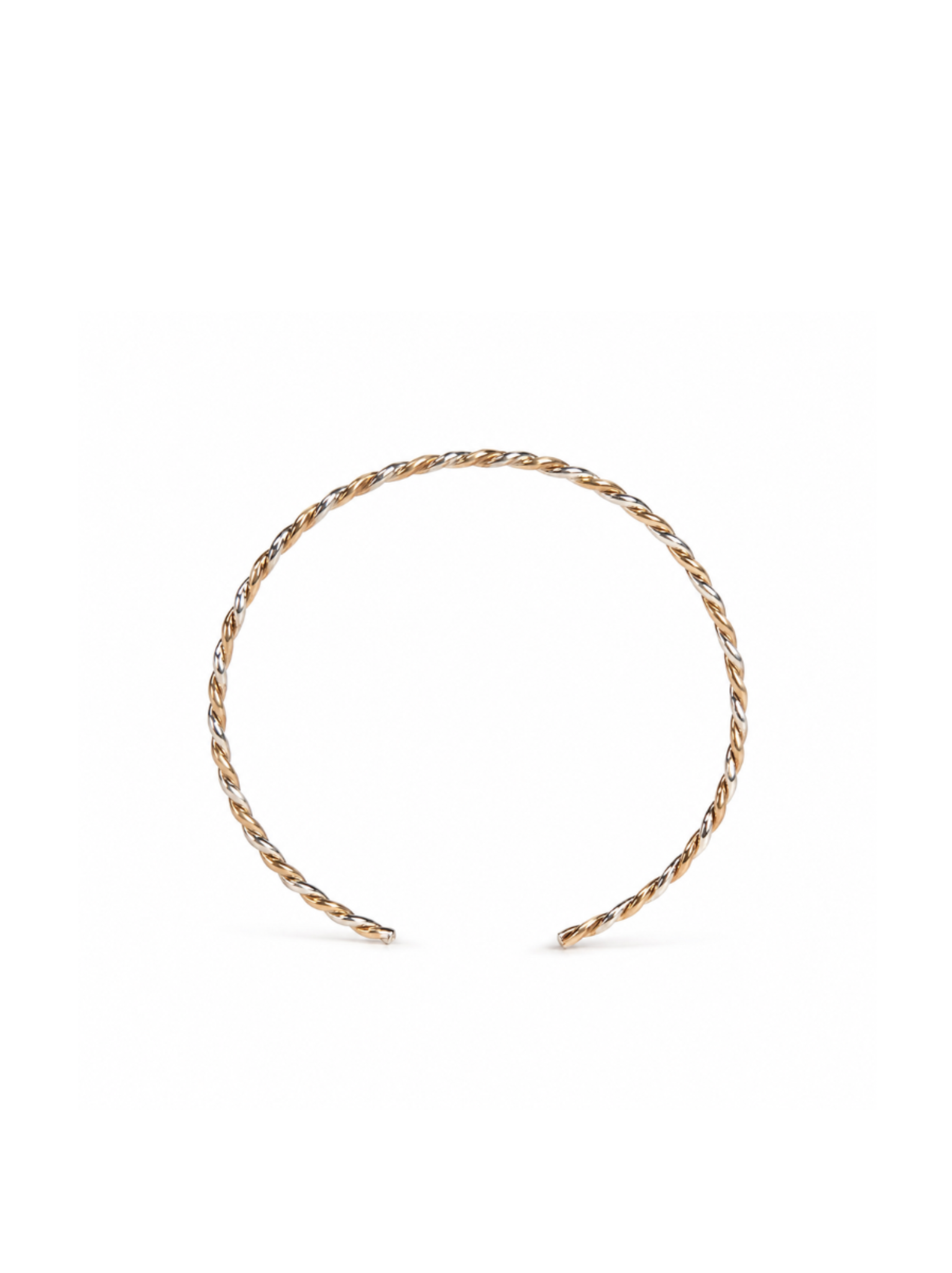 Braided gold and silver cuff bracelet standing up on white background.