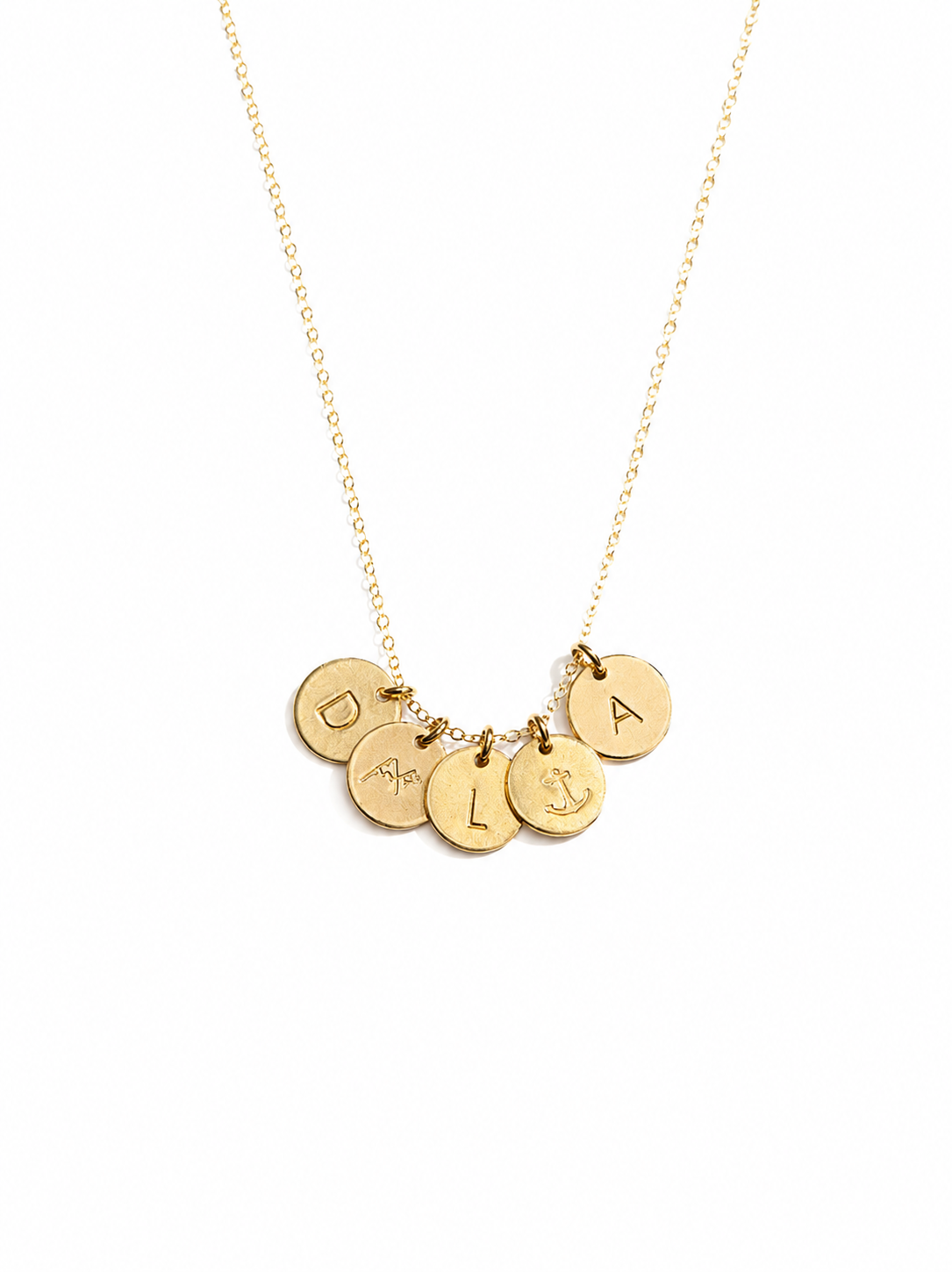 A delicate gold chain necklace featuring five small round gold charms, each stamped with a different letter or symbol (D, mountains, L, anchor, A), displayed on a clean white background. #Color_14k Gold-filled
