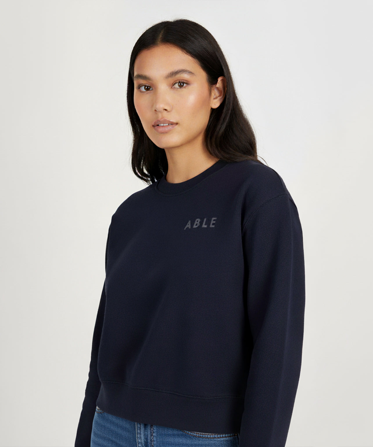 Person wearing ABLE Signature Crew sweatshirt with 'ABLE' logo on a white background