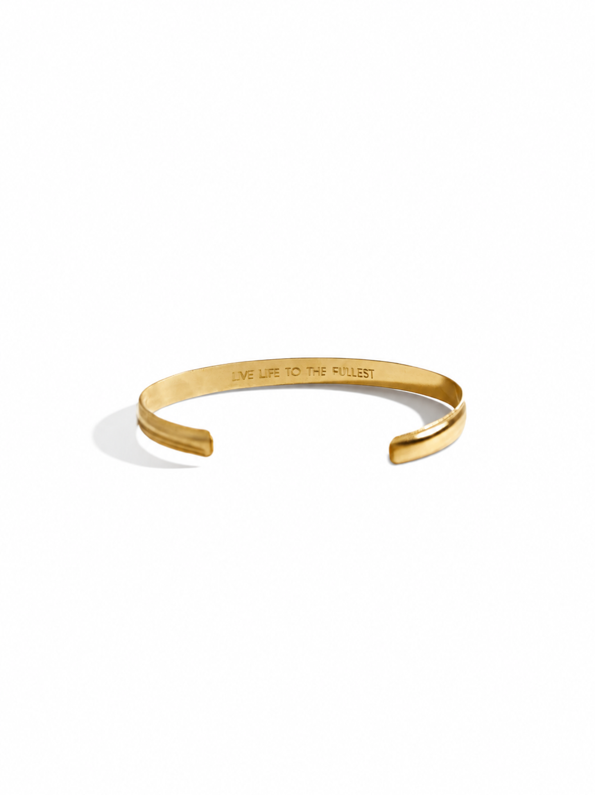 Inside of a gold-filled cuff bracelet with engraving on a white background.