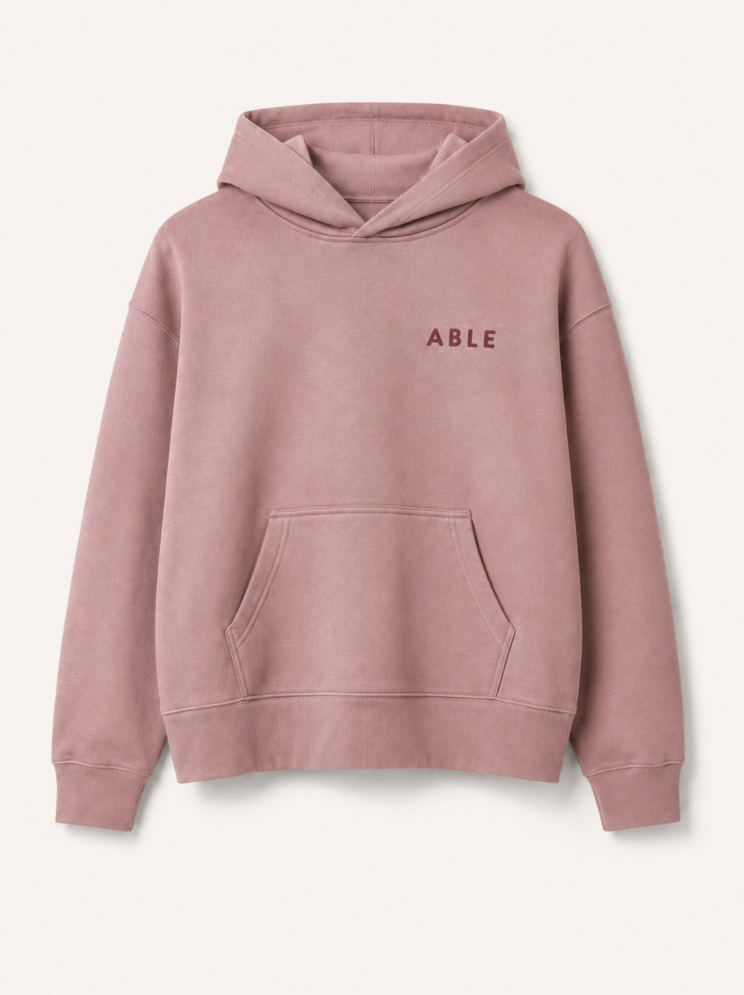 A dusty pink pullover hoodie with 'ABLE' printed in matching pink text on the left chest, displayed on a clean off-white background. #Color_Hazel Pink