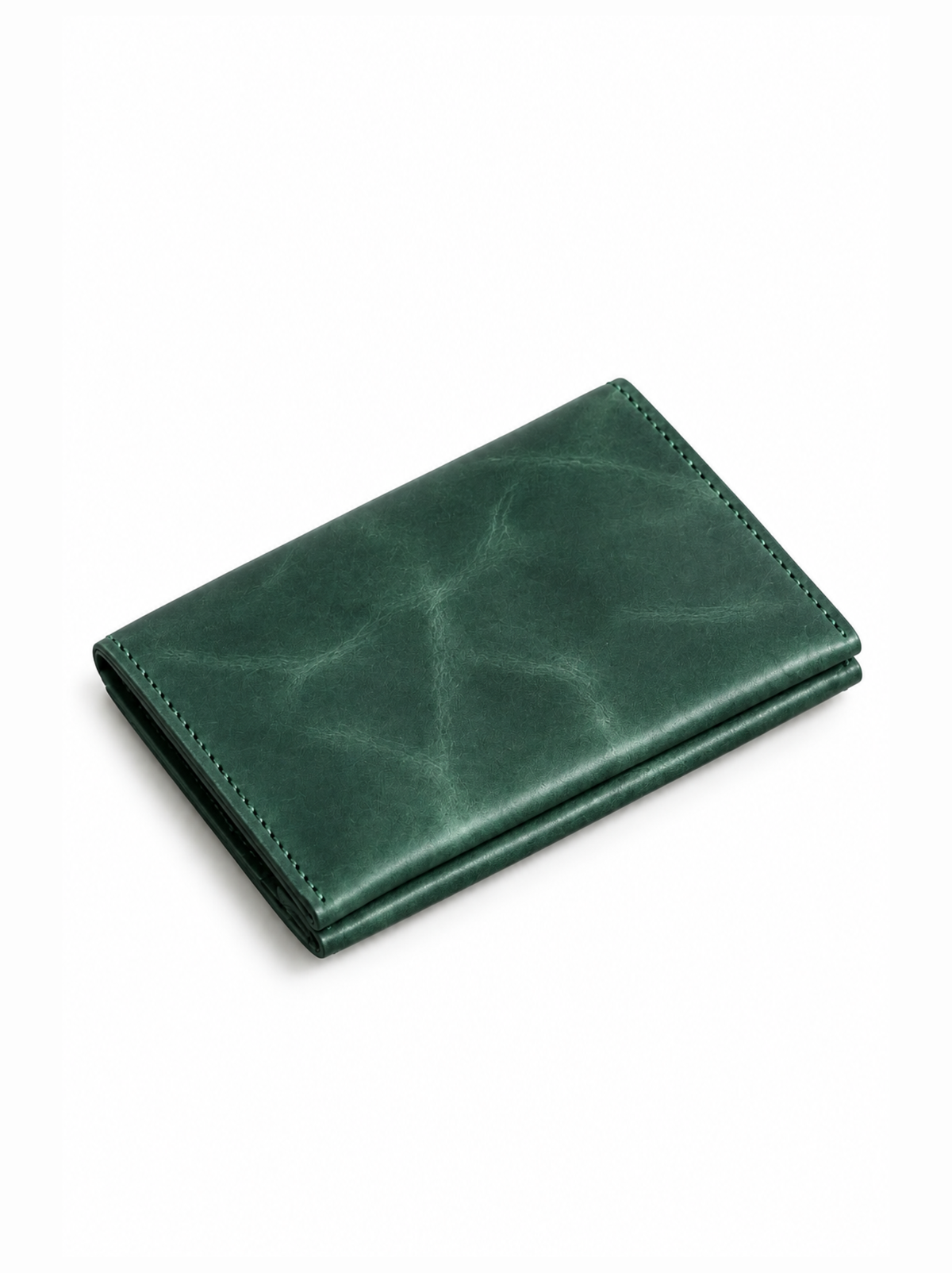 A dark green leather bifold wallet with a distressed texture and visible stitching, shown on a plain white background. #Color_Juniper