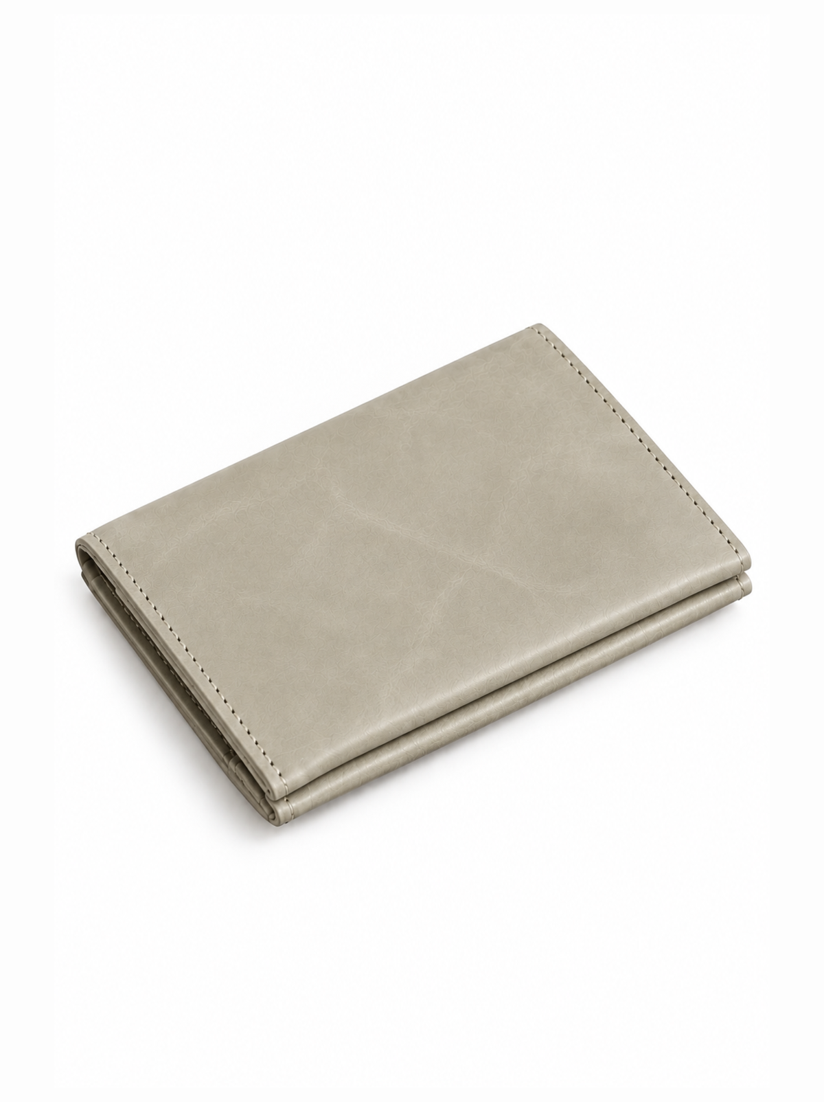 A light taupe leather bifold wallet with visible stitching on the edges, shown closed on a clean white background. #Color_Mushroom