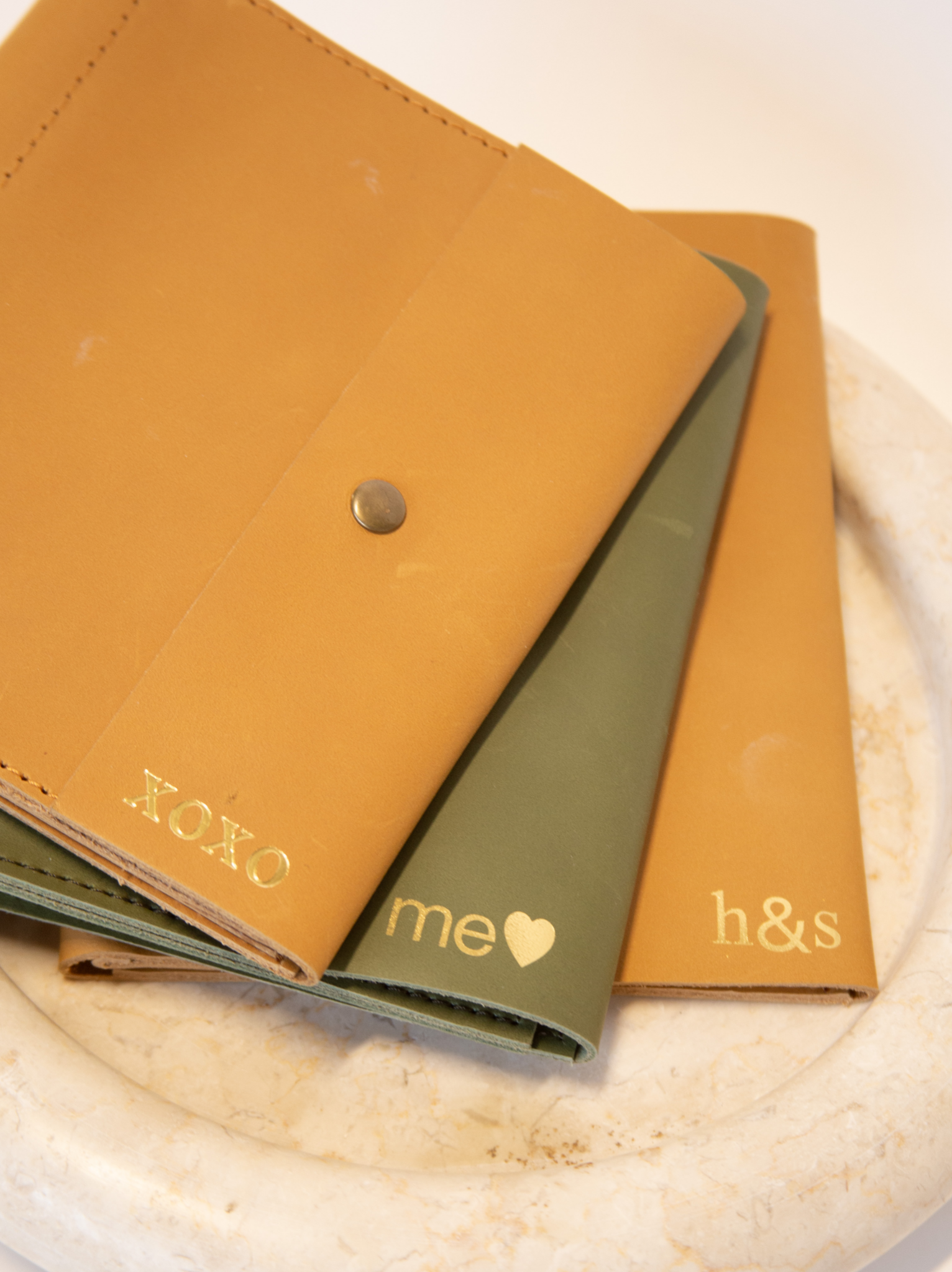 Three jewelry snap cases with gold foil letter and shape personalization on bottom of flap closure. #Color_Cognac