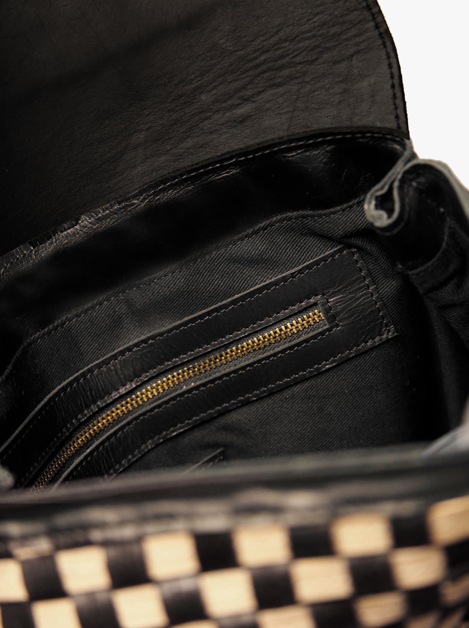 Black lined interior of black and tan basketweave backpack, with interior zip pocket. #Color_Black/Tan