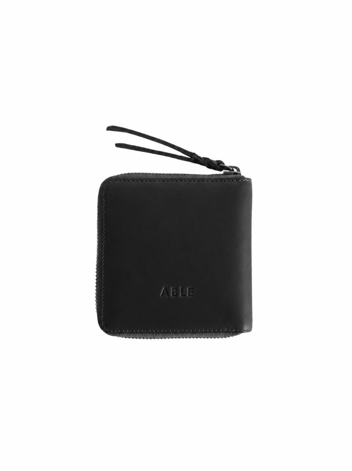 The back of a black leather zip-around wallet with a debossed 'ABLE' logo at the  bottom center, shown on a plain white background. #Color_Black