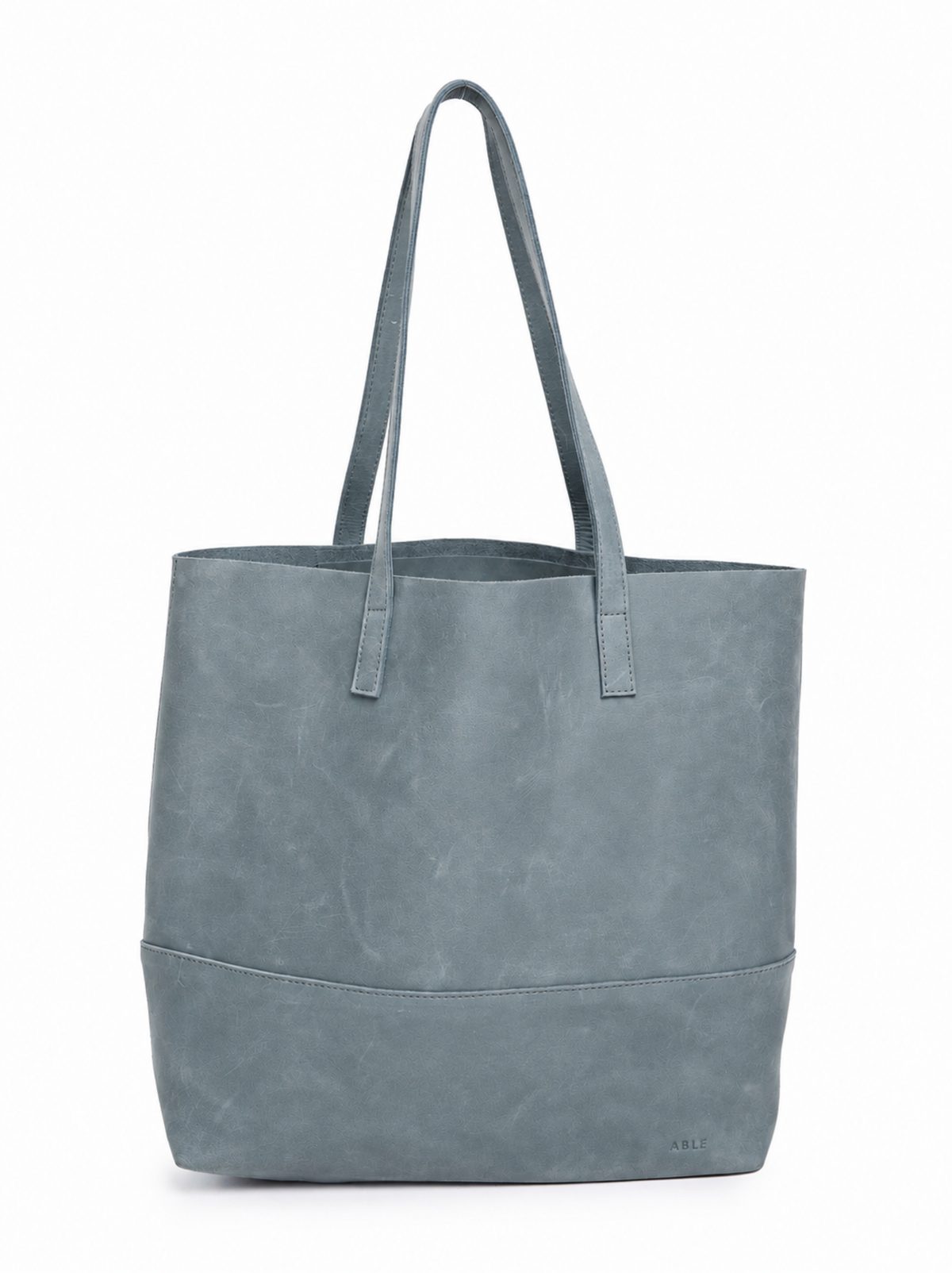 A light blue leather tote bag with dual shoulder straps and a structured rectangular shape, shown against a plain white background. #Color_Mist