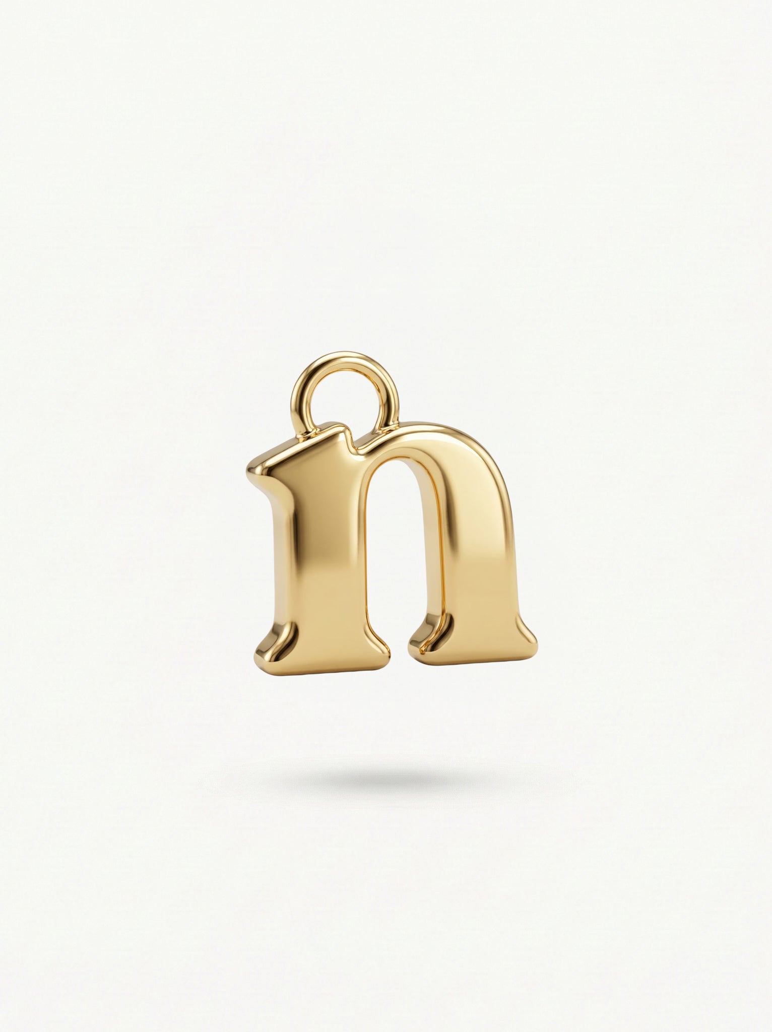 Initial Charm Gold Vermeil; Gold letter 'n' pendant on a light background