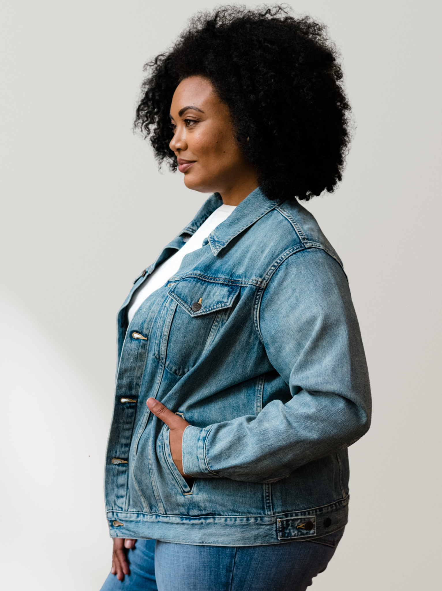 Woman wearing The Merly Jacket against a plain background