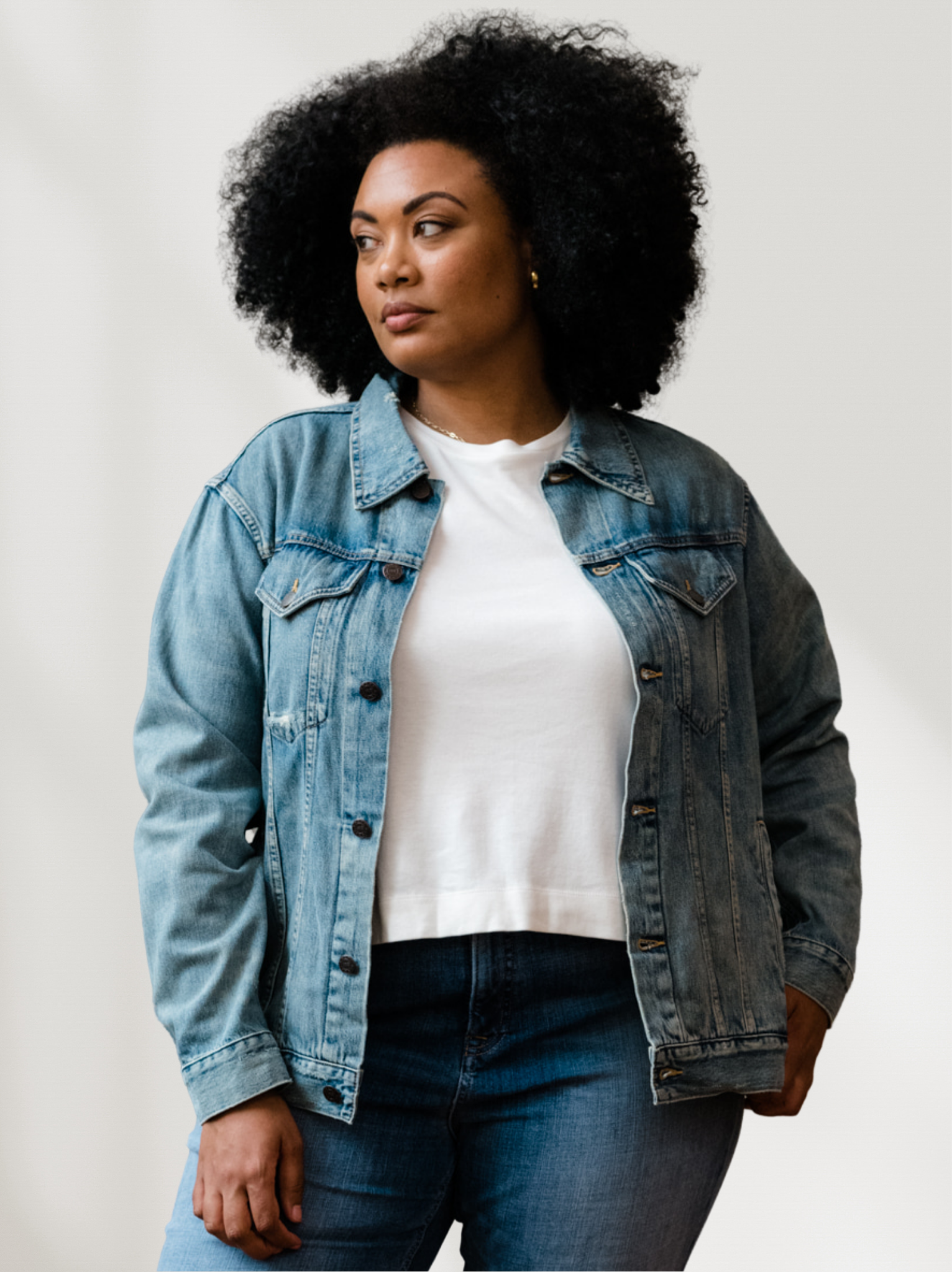 Person wearing The Merly Jacket over a white shirt with a plain background