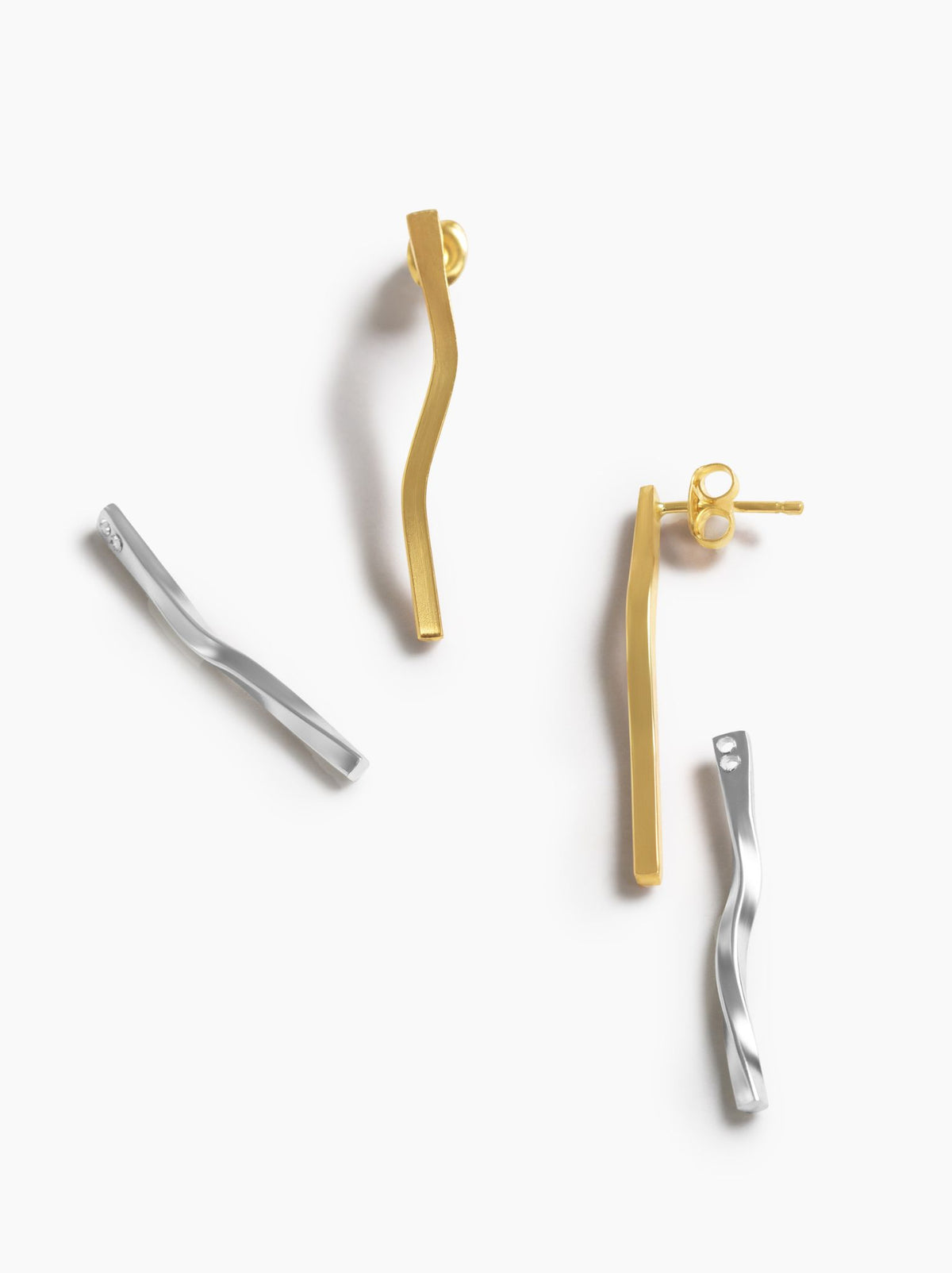 Set of gold and silver earrings on a white background.