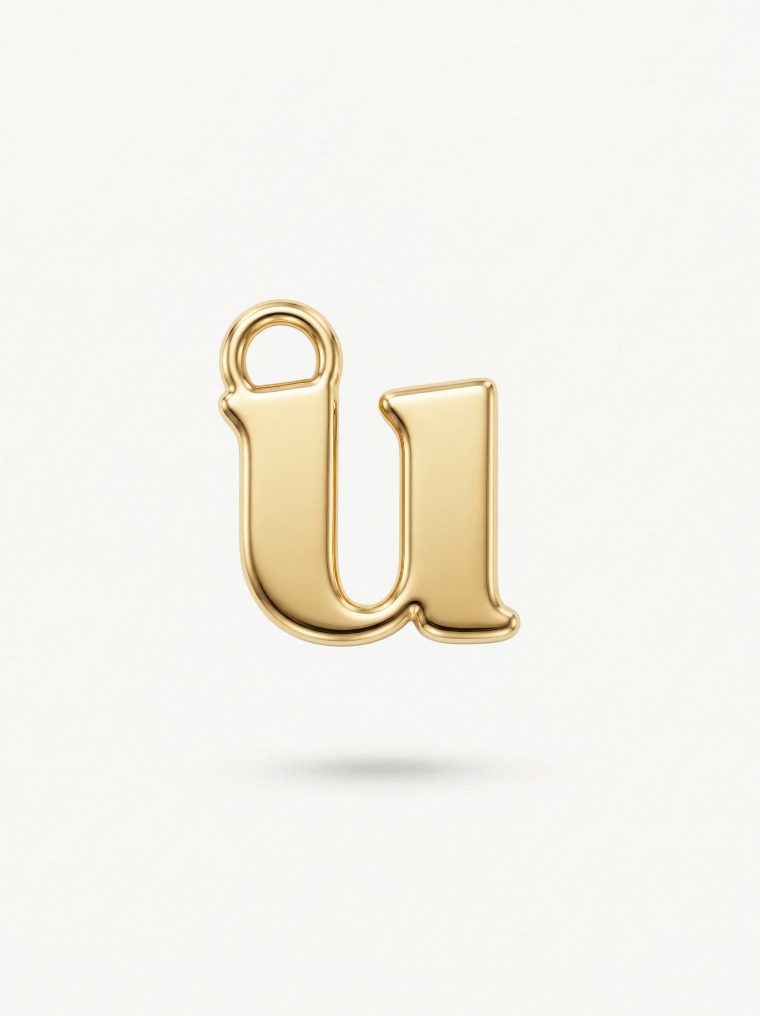 Initial Charm Gold Vermeil; Gold letter 'u' charm on a white background