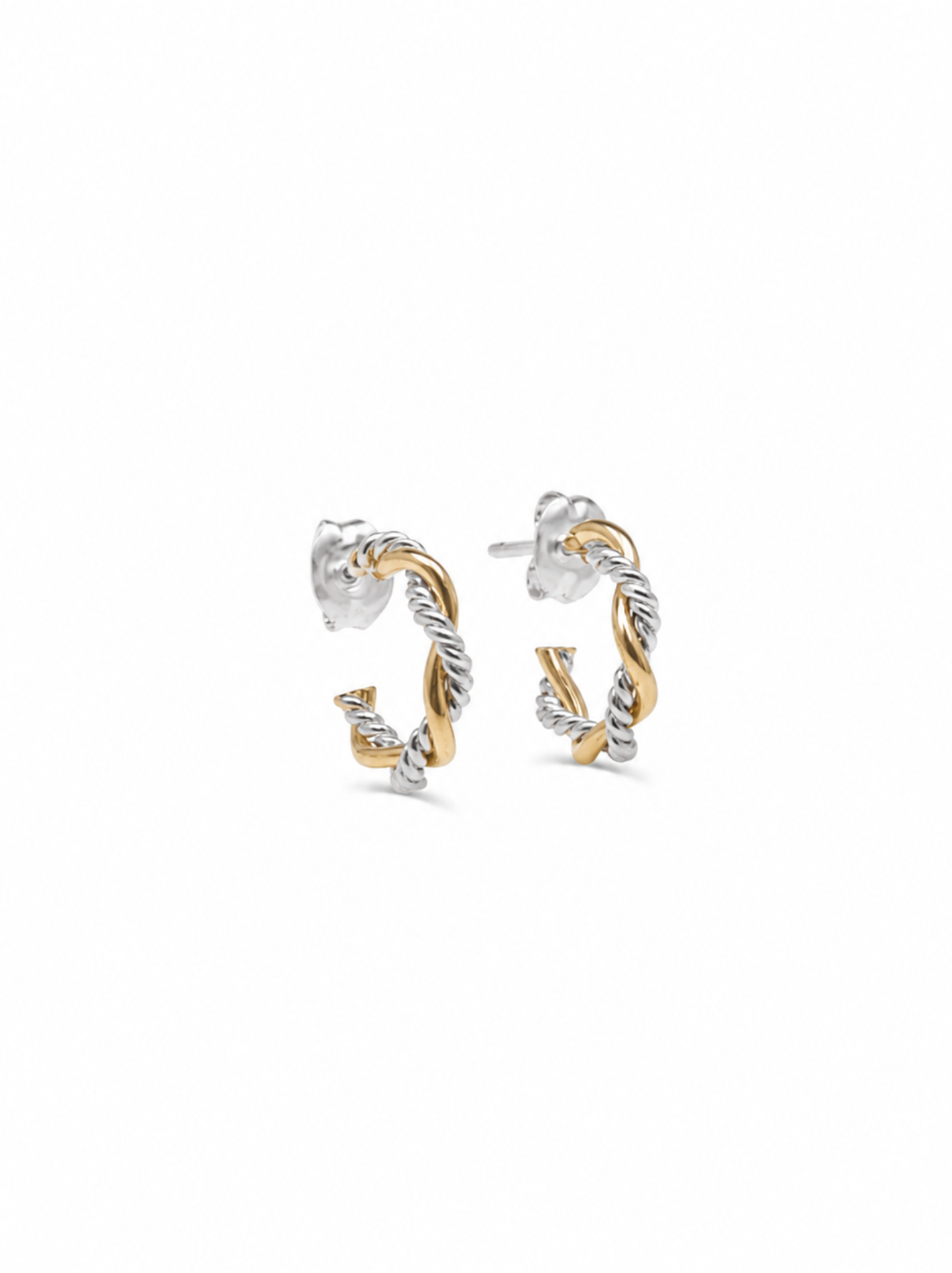 Angled detail view of a pair of mini braided hoop earrings with a smooth gold and textured silver finish on a white background.