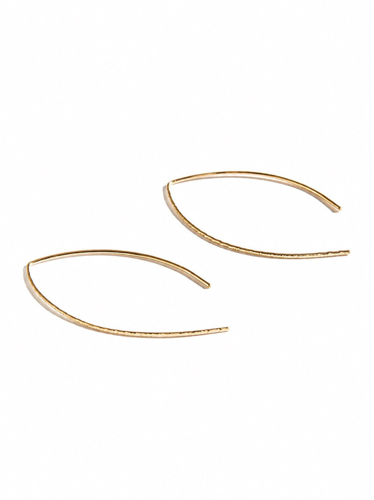 Pair of gold earrings on a white background