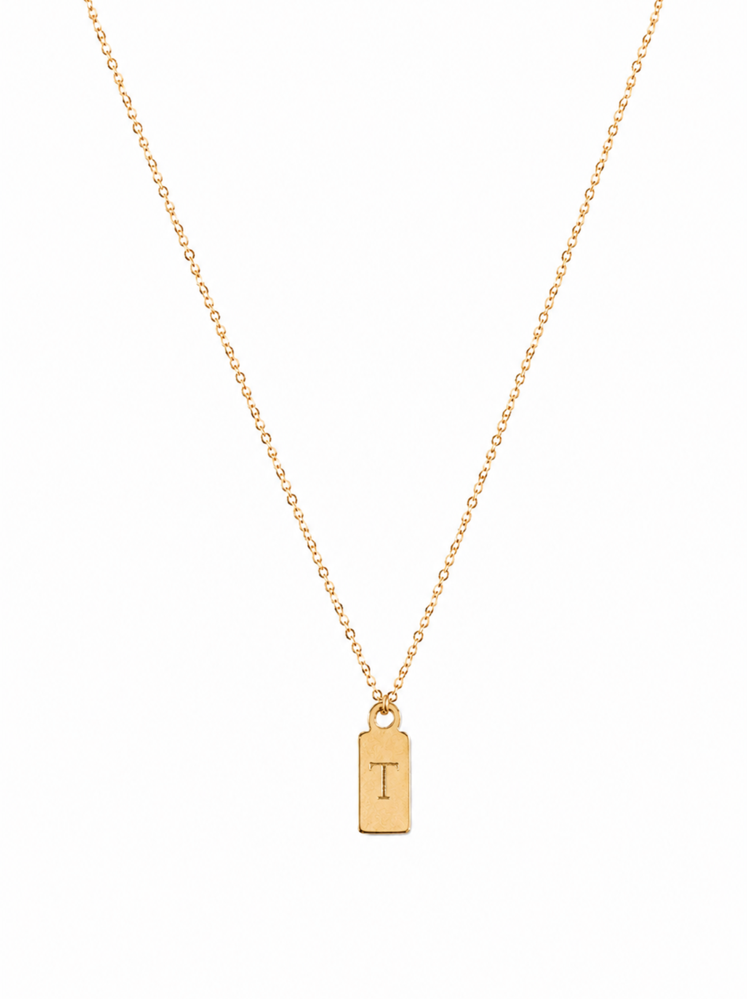 Gold necklace with a pendant featuring the letter 'T' on a white background.
